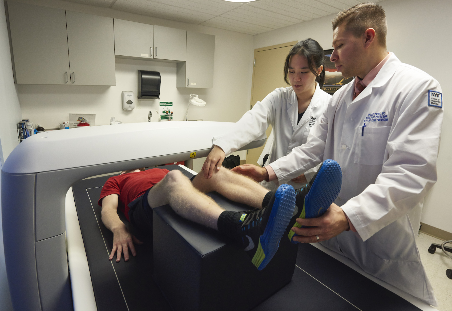 Image of doctors aiding a patient with leg discomfort